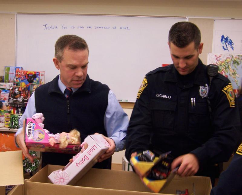 Members of the Marion Police Department pack up donated gifts for foster children following their annual toy drive. BY MATTHEW BERNAT